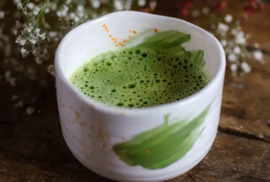 Cup of green tea with text ‘Does green tea cause dehydration?